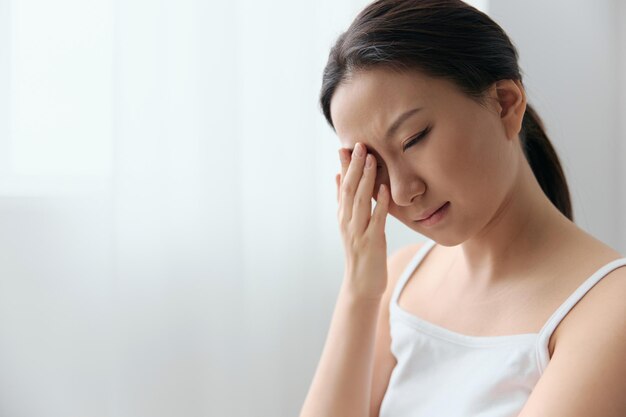 Side view of young woman looking away at home