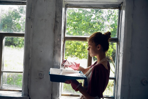 Photo side view of young woman looking through window