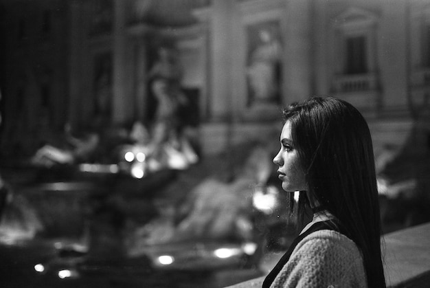 side view of young woman at night