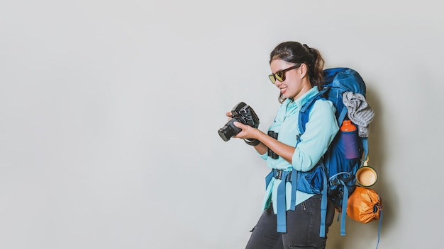 Side view of young woman photographing against white background
