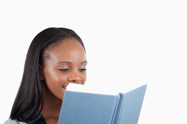 Side view of young woman reading a book