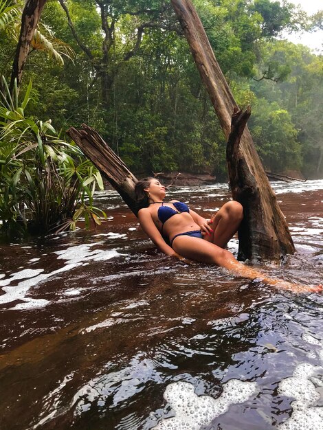 Side view of young woman relaxing on water