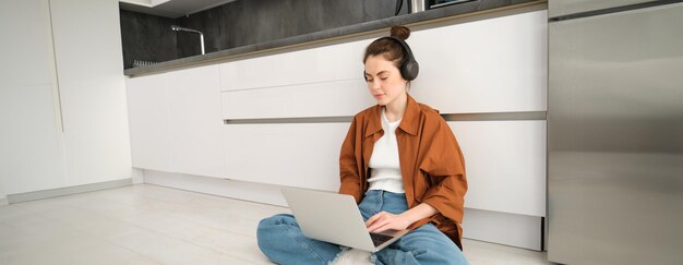 Side view of young woman sitting on floor