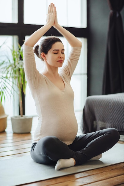 Side view of young woman sitting at home