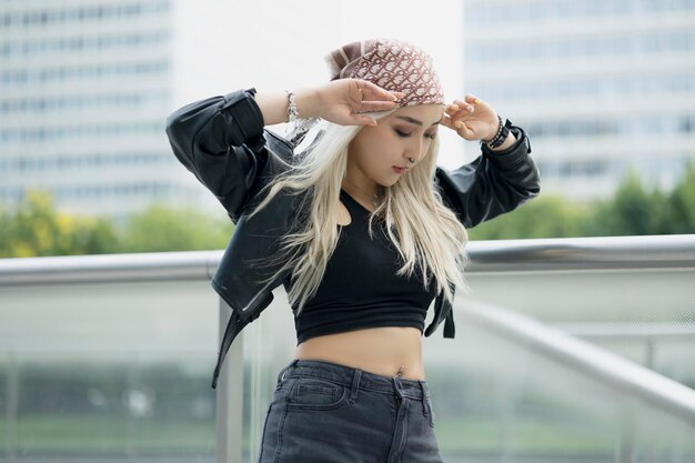 Side view of young woman standing against window