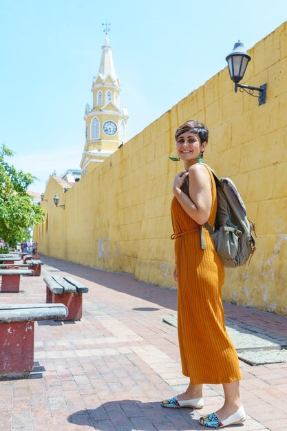 Side view of young woman standing in city