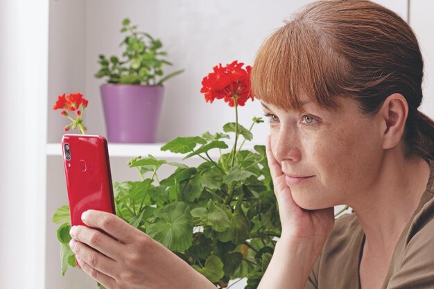 Side view of young woman using mobile phone at home