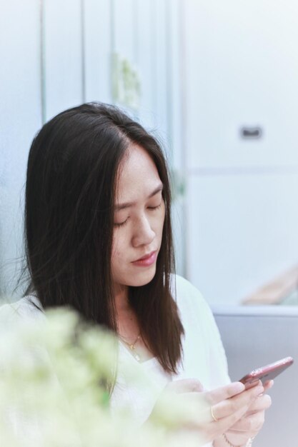 Side view of young woman using mobile phone