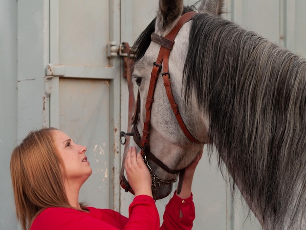 Side view of young woman with horse