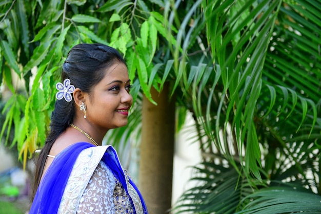 Side view of young woman with plants