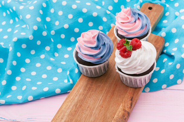 Side view of yummy cupcakes with assorted flavor. Shot on the table