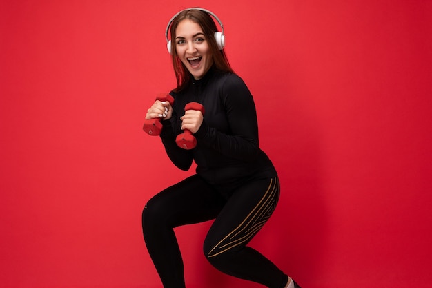 Sideprofile beautiful positive smiling young brunette female person wearing black sport