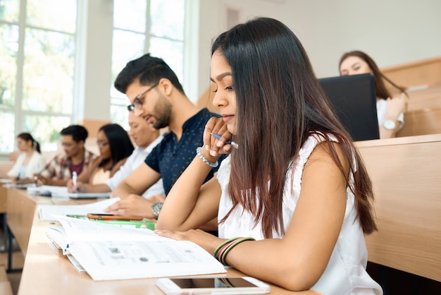 Sideview of young student prepearing for exams in university.