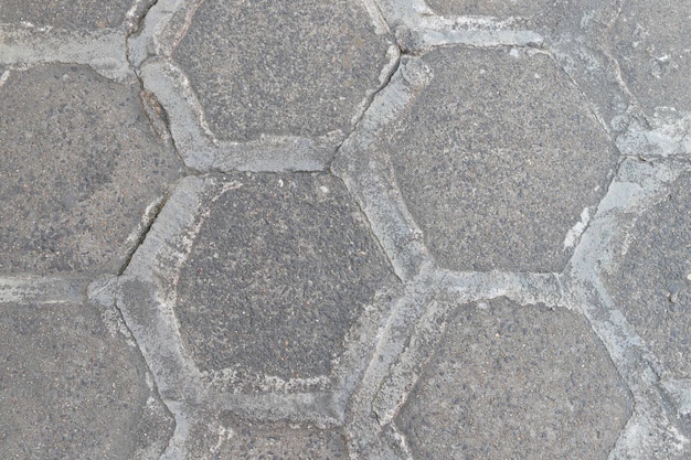 Sidewalk paved with concrete hexagons joints sealed with concrete to prevent weeds from growing in between