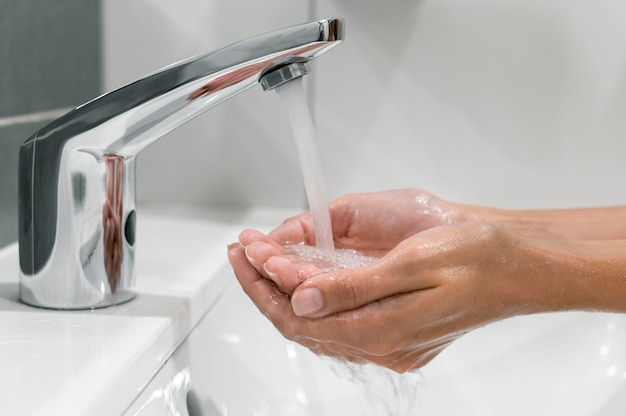 Sideways woman washing hands