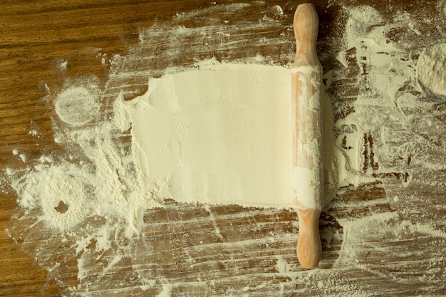 Sifted flour and rolling pin on the table 