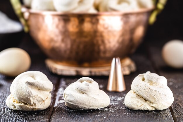 Sigh or meringue, typical Brazilian and French sweet, in antique copper pot, rustic cuisine