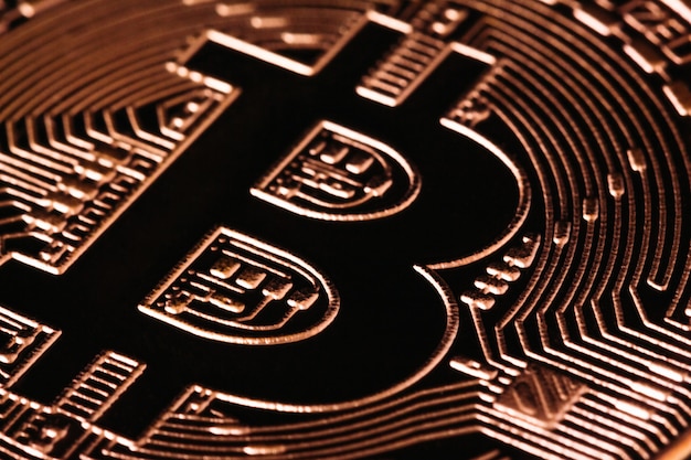 Sign bitcoin in gold close-up macro