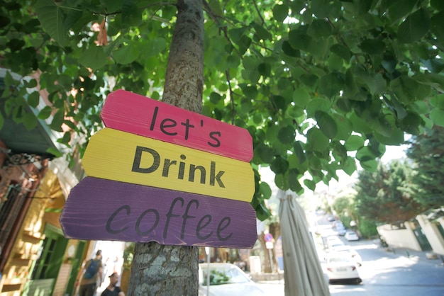 A sign at a coffee shop offering different types of coffee