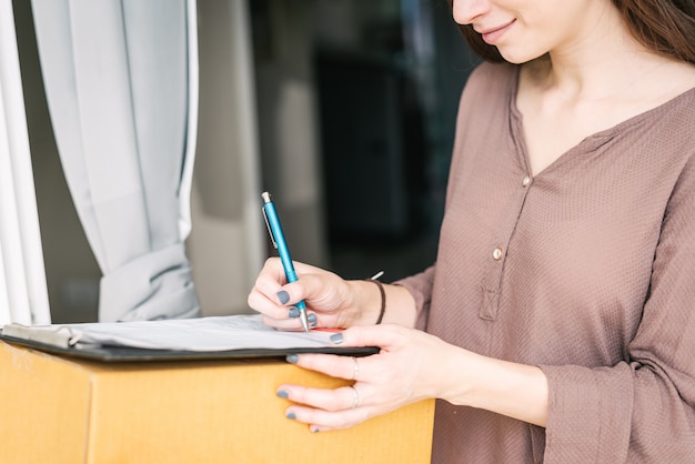 Sign document to receive package from courier 