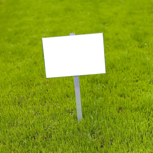 Photo sign on grass with isolated copy space for caption