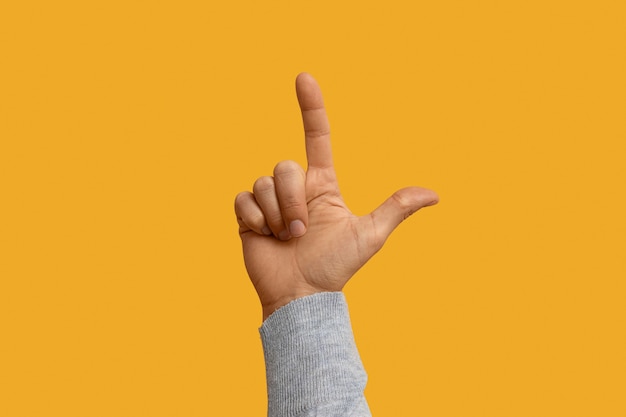 Photo sign language symbol isolated on yellow