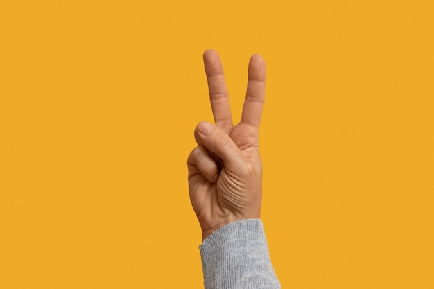 Photo sign language symbol isolated on yellow