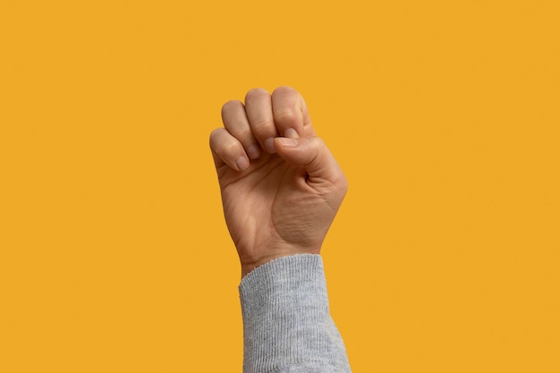 Photo sign language symbol isolated on yellow