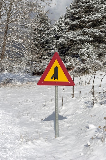 Sign quotAdjacent secondary roadquot on a winter day on a mountain road