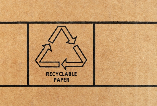 Sign of recyclable paper printed on recycled cardboard. Close up.