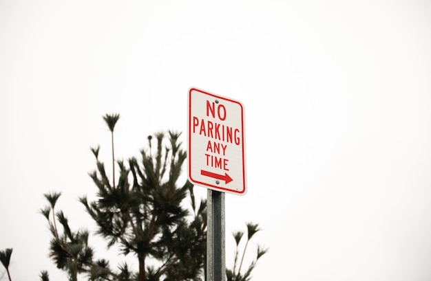 a sign that says no parking any time on it