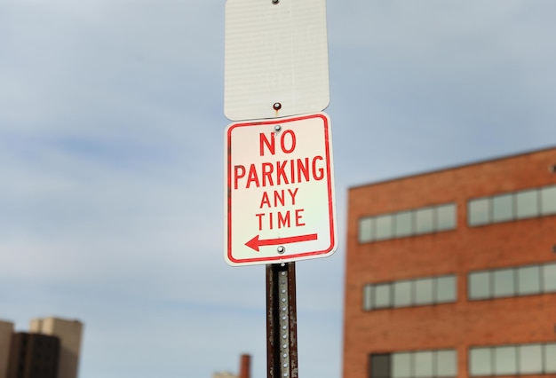 A sign that says no parking any time on it