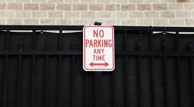 A sign that says no parking any time on it