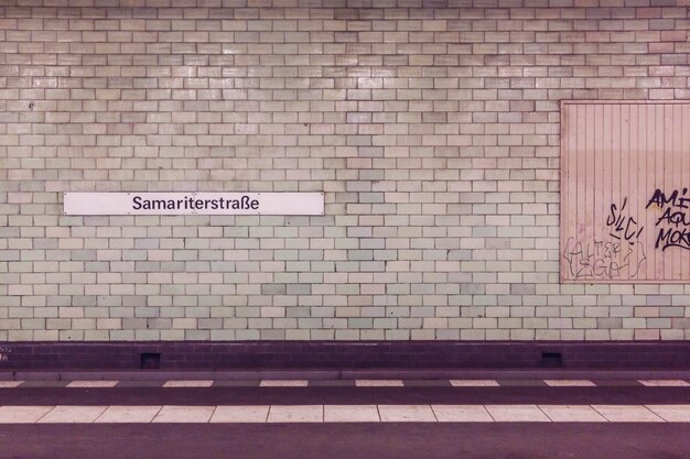 Sign on tiled wall at subway station