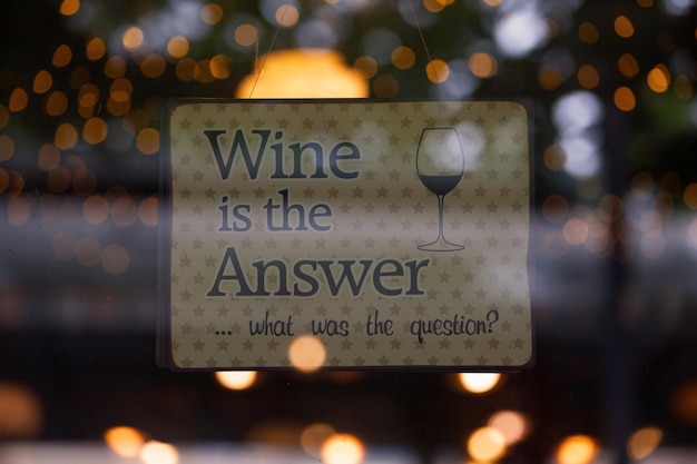 Sign in the window of a bar saying Wine is the answer What was the question