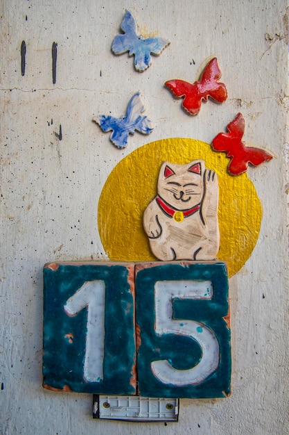 A sign with the number 15 butterflies and a cat