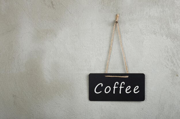 Signboard blackboard chalkboard with text Coffee and copy space grey cement wall