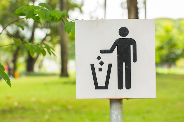 signboard of a man, throwing garbage in a bin