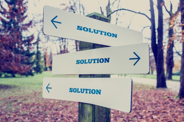 Photo signboard with the word solution with arrows pointing in three directions