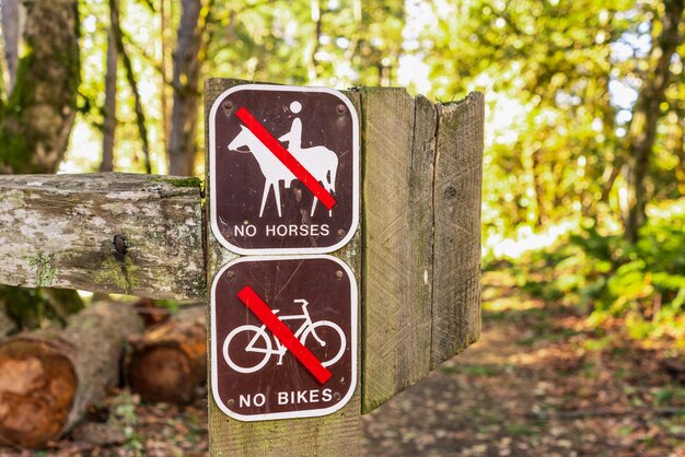 Signs posted at the entrance on one of the hiking trails warning that it is closed to bikes and horses Purisima Creek Redwoods Preserve Santa Cruz mountains California