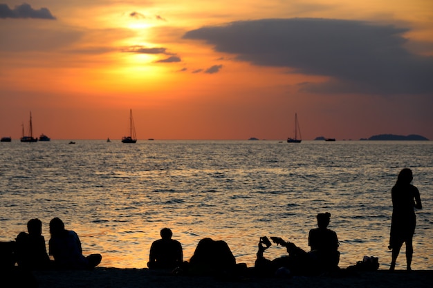 silhouet toerist Op het strand Zonsondergang