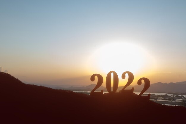 Silhouet van 2022 met een zonsopganghemelachtergrond. Gelukkig nieuwjaar 2022