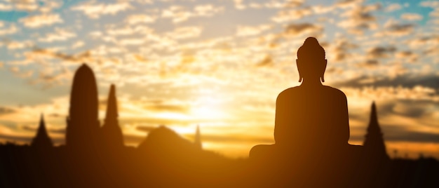 Silhouet van boeddha op gouden tempel zonsondergang. reisattractie in thailand.