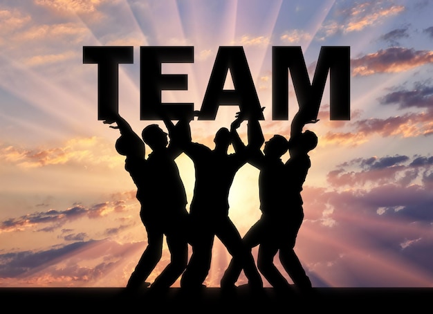 Silhouet van een groep mannen die het woord team boven zichzelf houden. het concept van een business team en teamwork