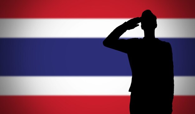 Silhouet van een soldaat die salueert tegen de vlag van thailand