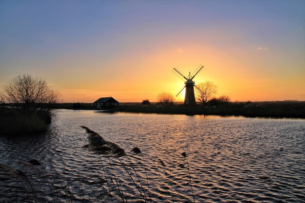 Silhouet van een traditionele windmolen tegen de hemel bij zonsondergang