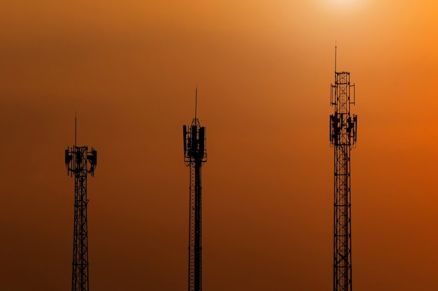 Silhouette 3 Telecommunication tower Antenna or radio tower at sunset sky.