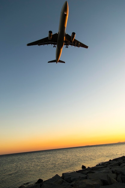 Silhouette of airplane approaching to runway