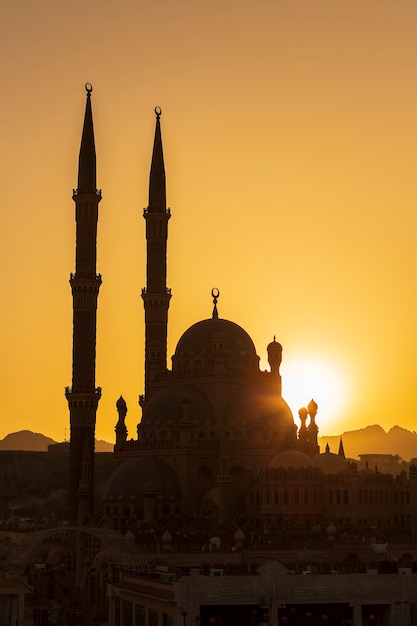 Silhouette Al-Sahaba Mosque at sunset time in Sharm el Sheikh, Egypt. Architecture of Al Sahaba, Al Mustafa, mosque in center of old town includes fusion of Fatimid, Mamluk and Ottoman style elements