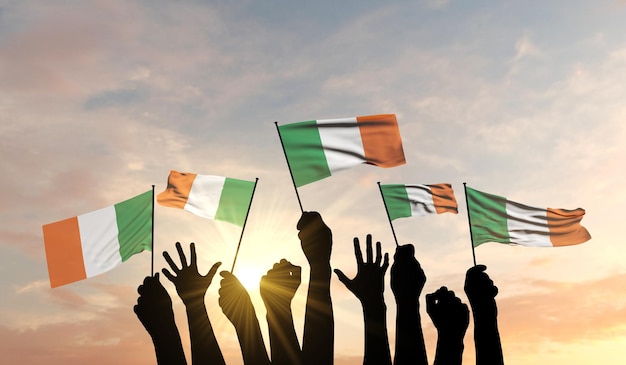 Silhouette of arms raised waving an ireland flag with pride d rendering